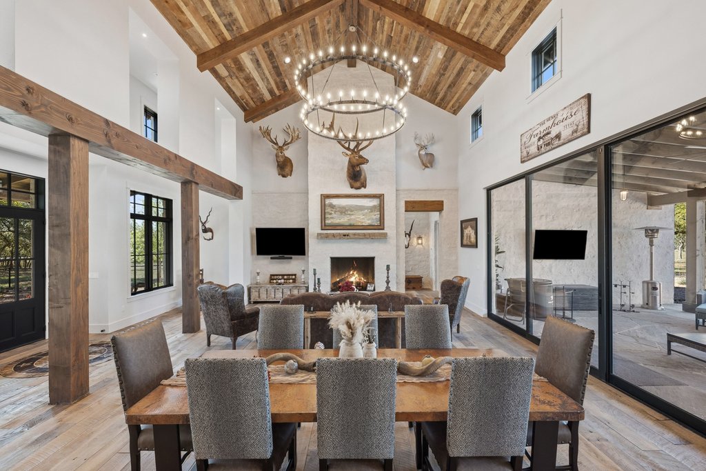 1660 Windmill Run Wimberley, TX 78676 - Photo 5 of 40 a view of a dining room with furniture a chandelier and wooden floor