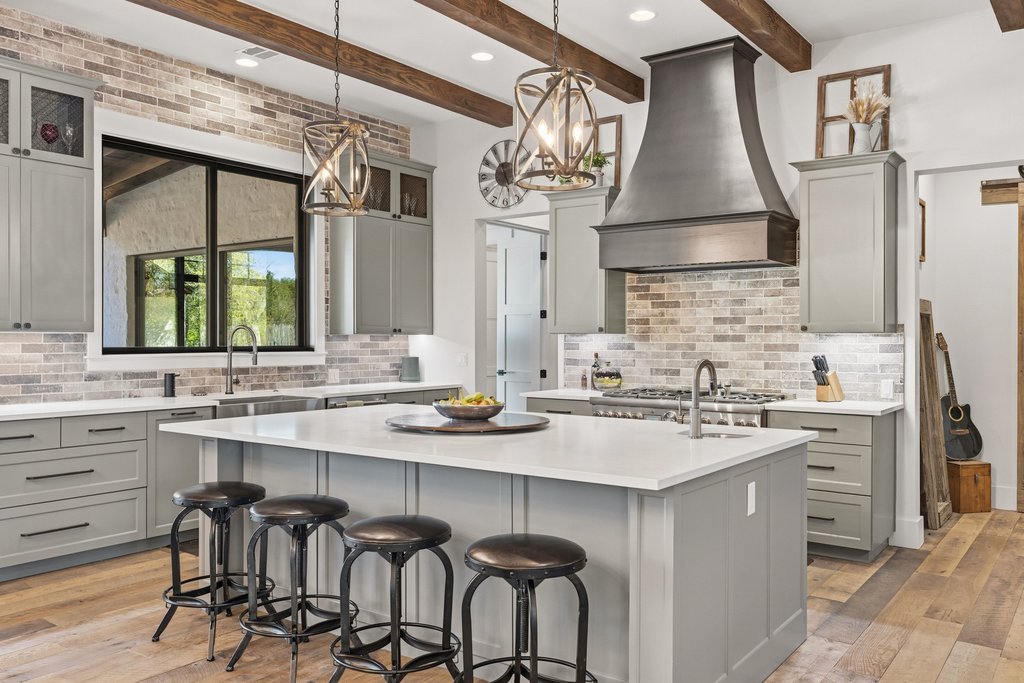 1660 Windmill Run Wimberley, TX 78676 - Photo 9 of 40 a kitchen with a sink stove and cabinets