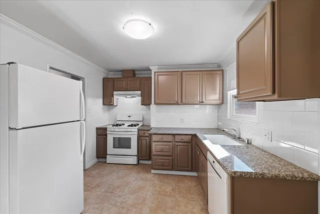 a kitchen with a sink a stove and refrigerator