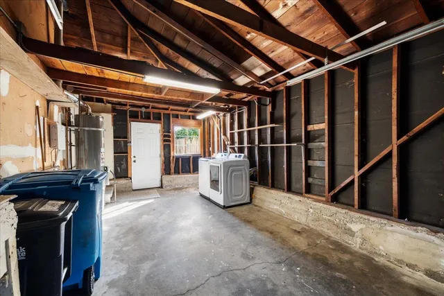 a view of an empty room with wooden walls and furniture