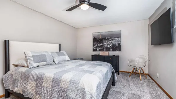 a bedroom with a bed and a television