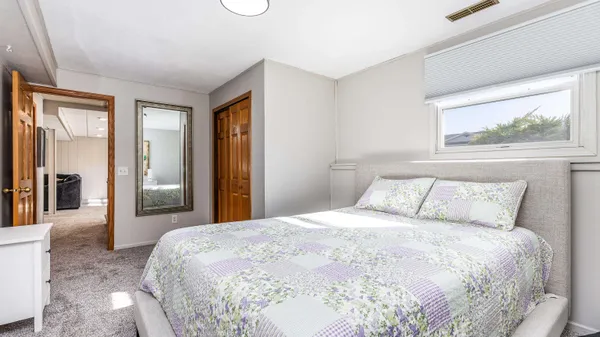 a bedroom with a large bed and a chandelier