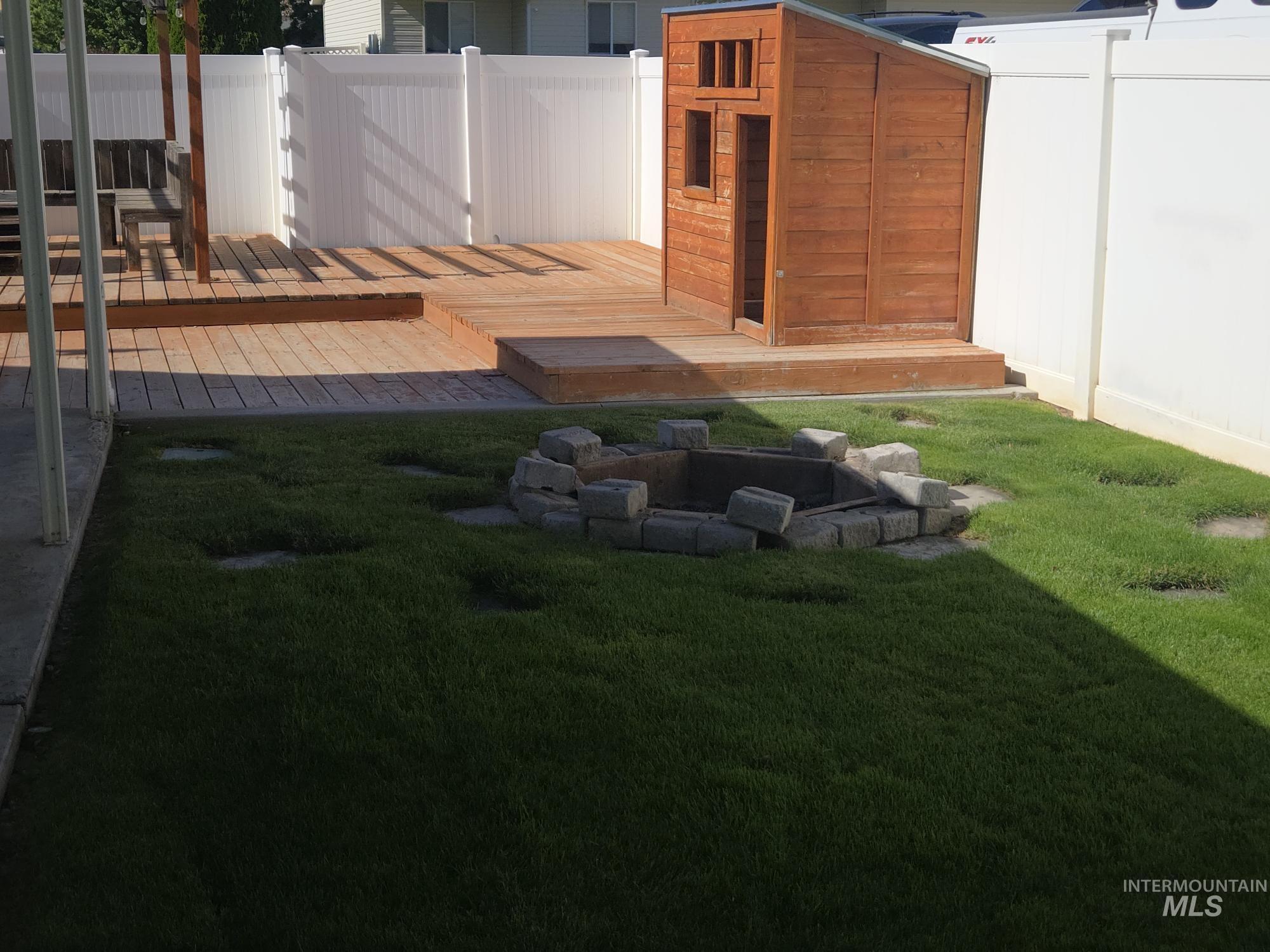 2480 West 9th Street Weiser, ID 83672 - Photo 8 of 17 Expansive green lawn with a stone-surrounded fire pit