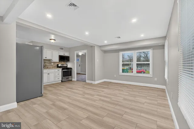 a view of kitchen with stainless steel appliances kitchen island granite countertop a stove and a refrigerator