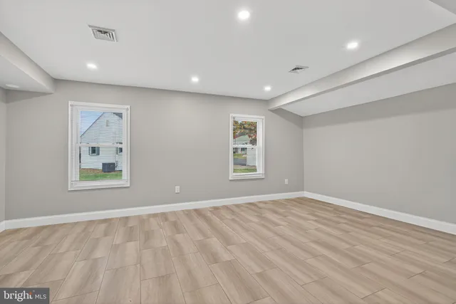 an empty room with windows and closet