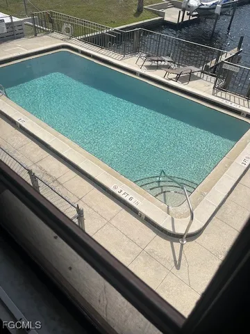 an aerial view of a house with swimming pool and outdoor seating