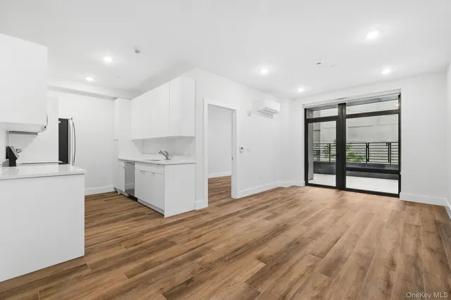a view of a kitchen with wooden floor
