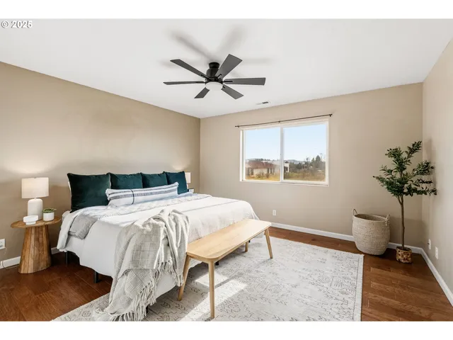 a bedroom with a bed and a potted plant