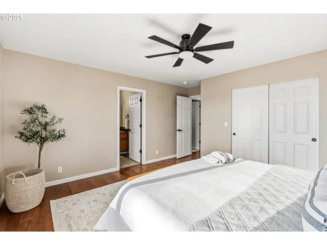 a bedroom with a bed and a potted plant