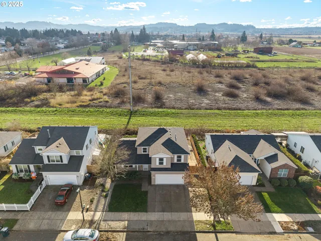 an aerial view of a house with a big yard