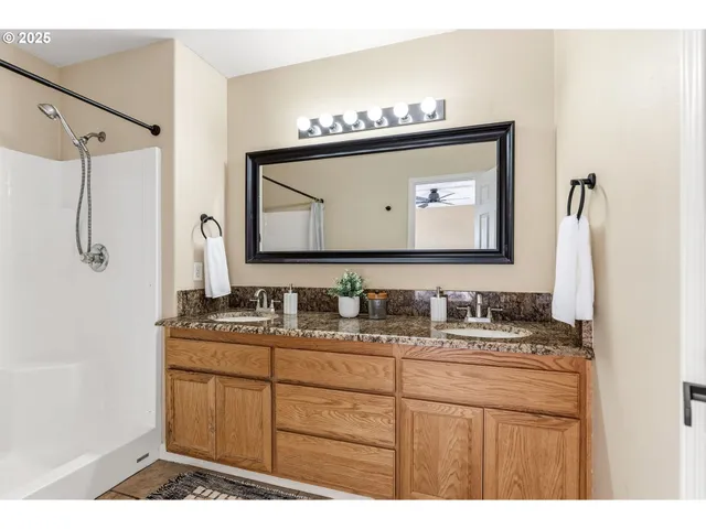 a bathroom with a sink vanity and a mirror