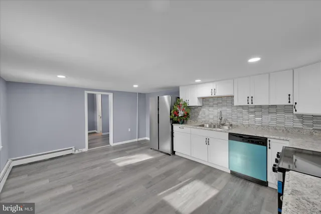 a kitchen with stainless steel appliances a refrigerator sink and stove