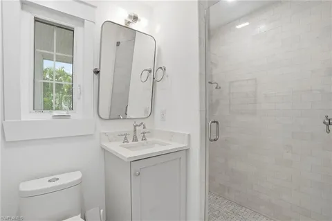 a patio with glass top table and chairs