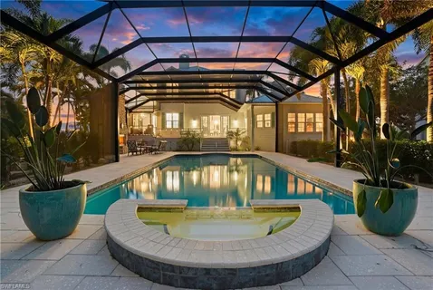 a balcony with chairs and a table