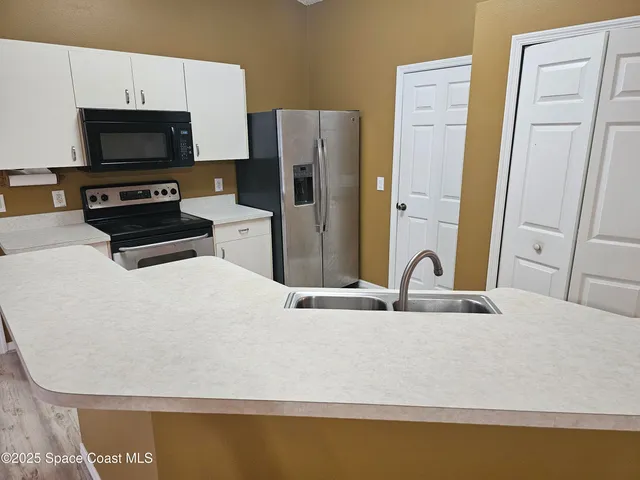 a room with a wooden floor and a sink
