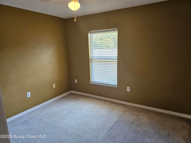 a view of an empty room with a door