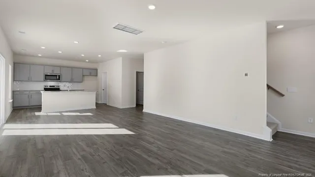 a view of kitchen with cabinets and wooden floor