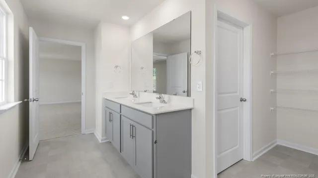 a bathroom with a granite countertop sink a toilet and shower