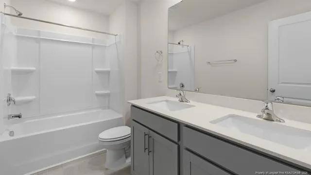 a bathroom with a double vanity sink mirror and double