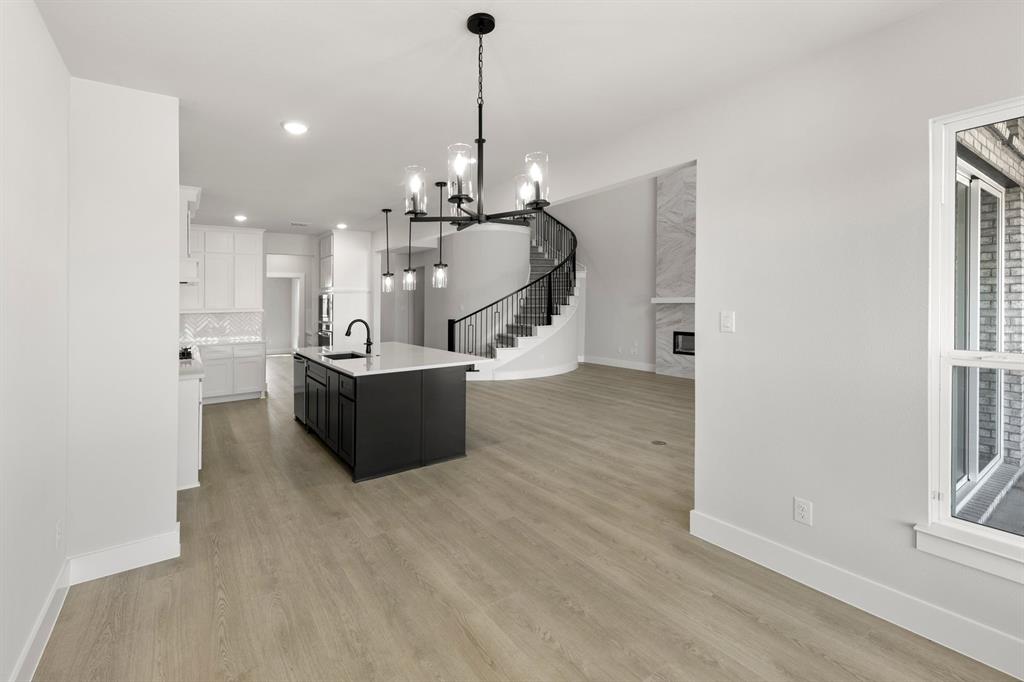 13709 Riola Drive Little Elm, TX 75068 - Photo 12 of 40 a view of a living room and kitchen with a sink