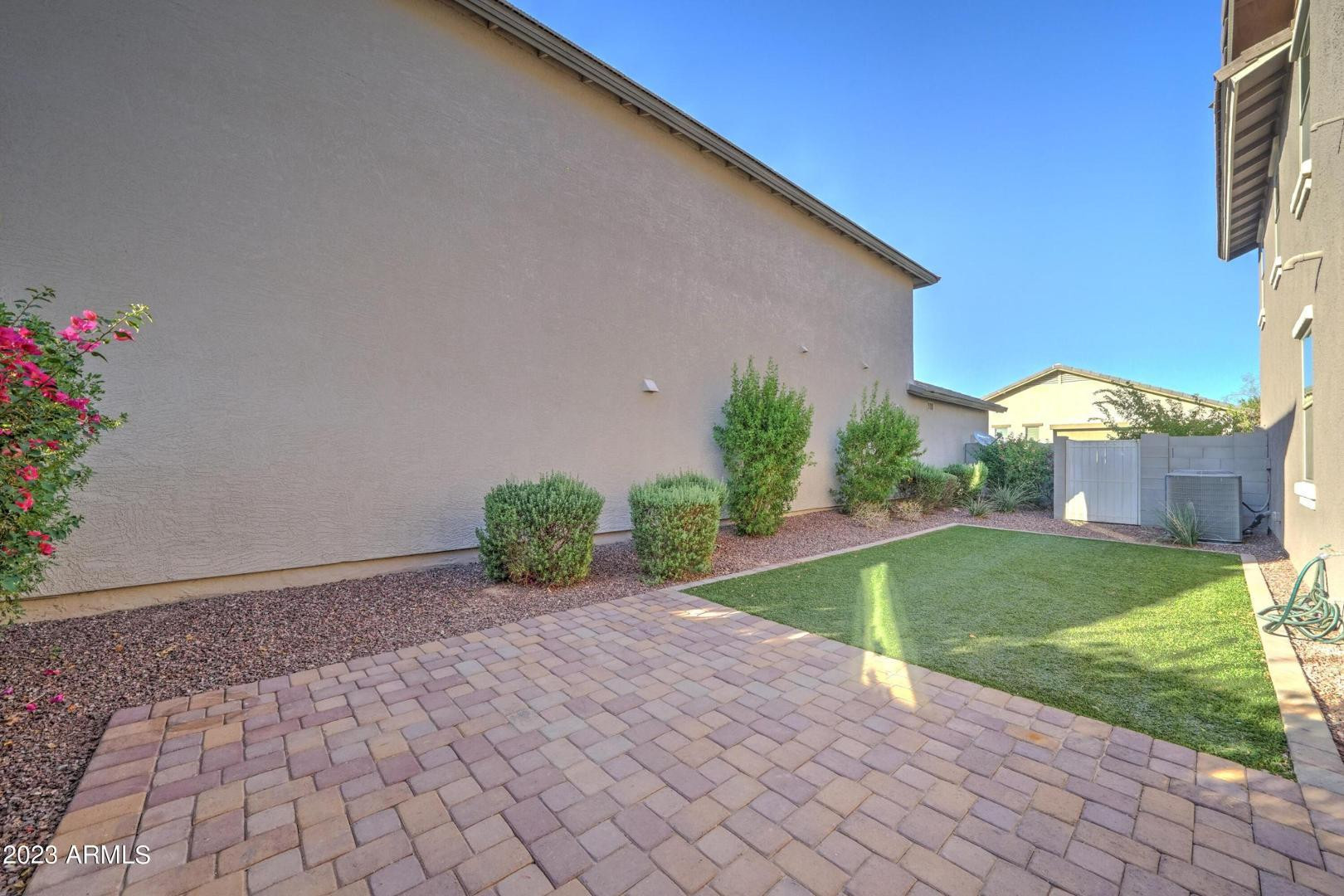 2297 North Alsap Road Buckeye, AZ 85396 - Photo 28 of 36 a front view of a house with a yard and potted plants