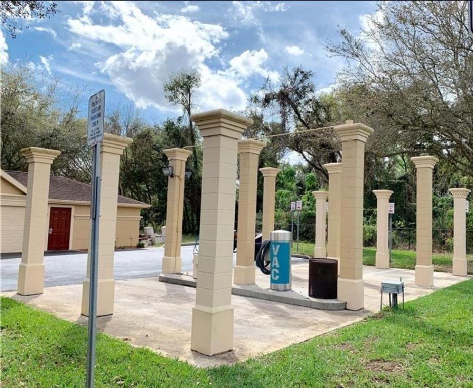 875 Grand Regency Pointe, Unit 203 Altamonte Springs, FL 32714 - Photo 13 of 17 a front view of a house with a yard garden and outdoor seating