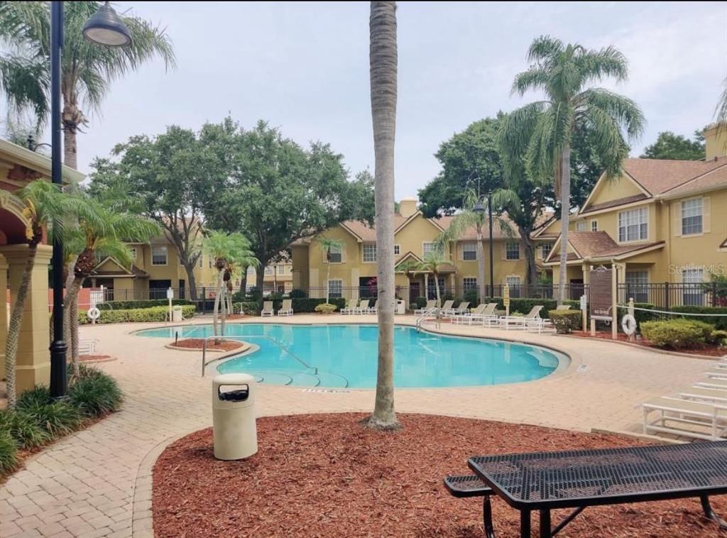 875 Grand Regency Pointe, Unit 203 Altamonte Springs, FL 32714 - Photo 16 of 17 a view of a house with swimming pool and sitting area