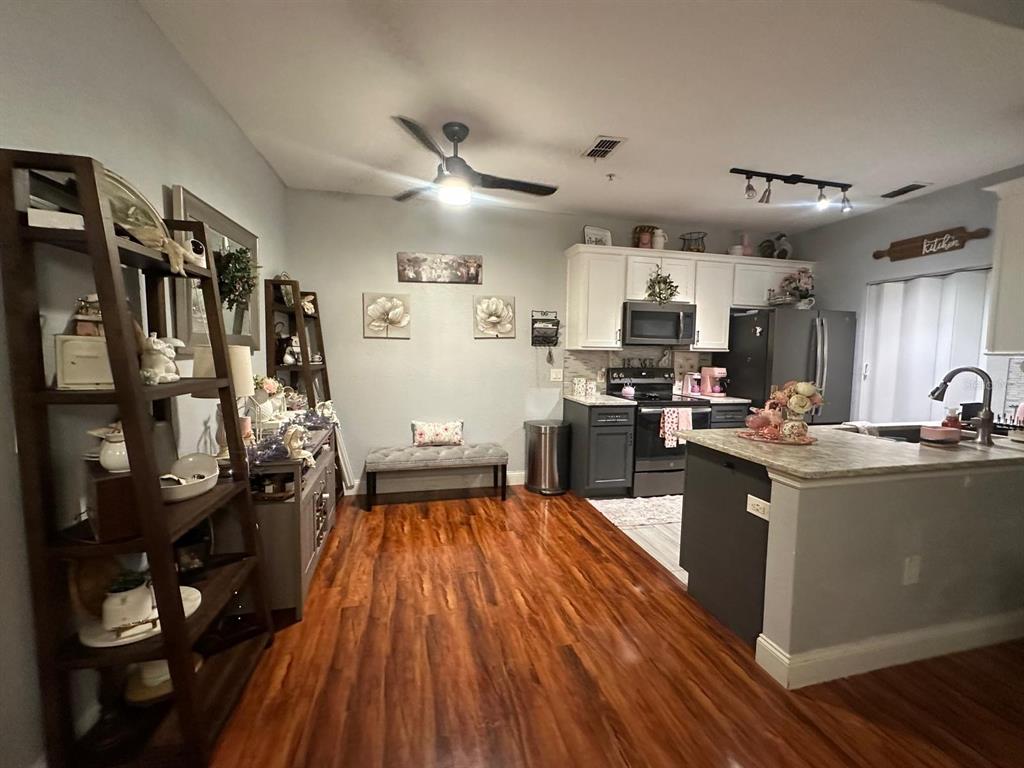 875 Grand Regency Pointe, Unit 203 Altamonte Springs, FL 32714 - Photo 2 of 17 a kitchen with stainless steel appliances granite countertop a stove and cabinets