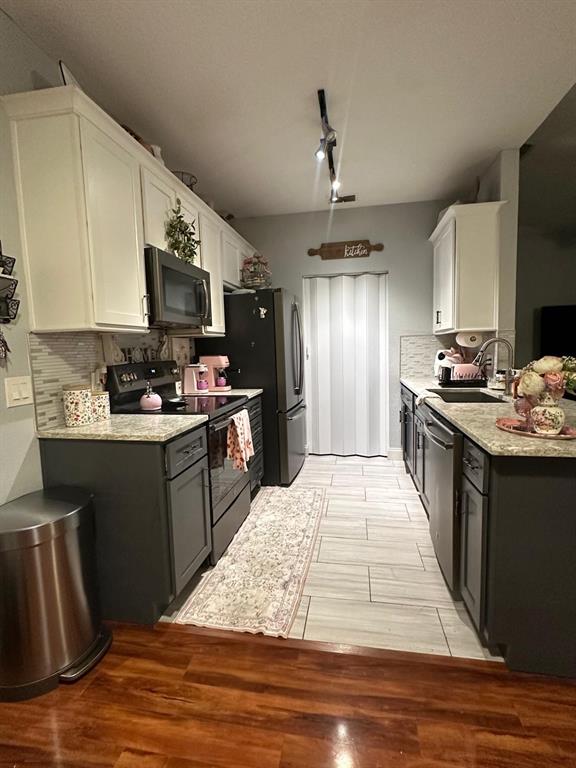875 Grand Regency Pointe, Unit 203 Altamonte Springs, FL 32714 - Photo 3 of 17 a kitchen with stainless steel appliances kitchen island granite countertop a sink stove and refrigerator