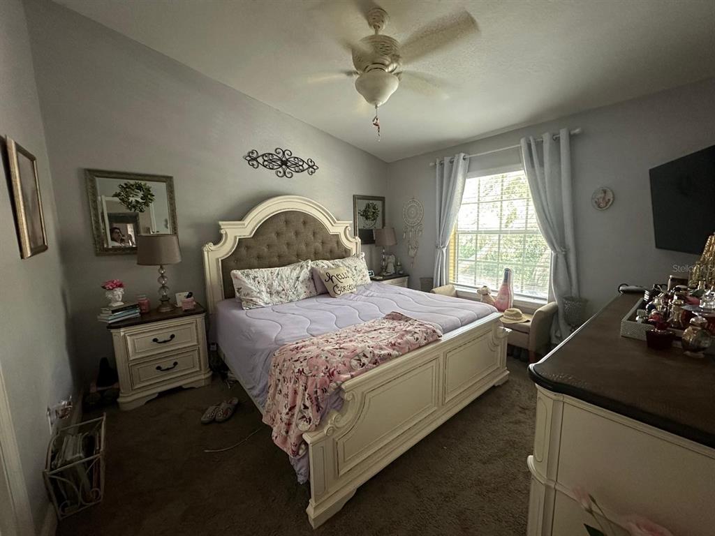 875 Grand Regency Pointe, Unit 203 Altamonte Springs, FL 32714 - Photo 9 of 17 a bedroom with a bed and a tv on dresser