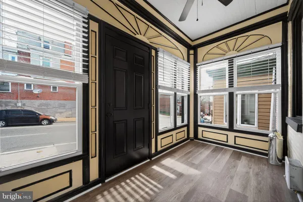 a view of a balcony with wooden floor and door
