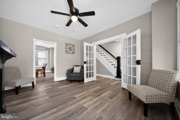 a living room with furniture and a wooden floor
