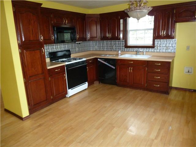 1820 Limestone Road Elora, TN 37328 - Photo 14 of 14 a kitchen with stainless steel appliances granite countertop a stove a sink and a refrigerator