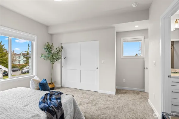 a bedroom with a bed and a potted plant