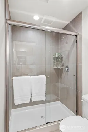 a bathroom with a shower and toilet