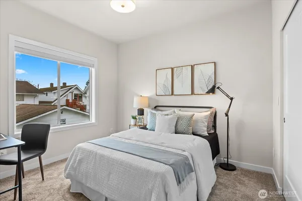 a bedroom with a bed and chair