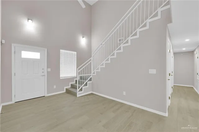 a view of entryway and hall with wooden floor