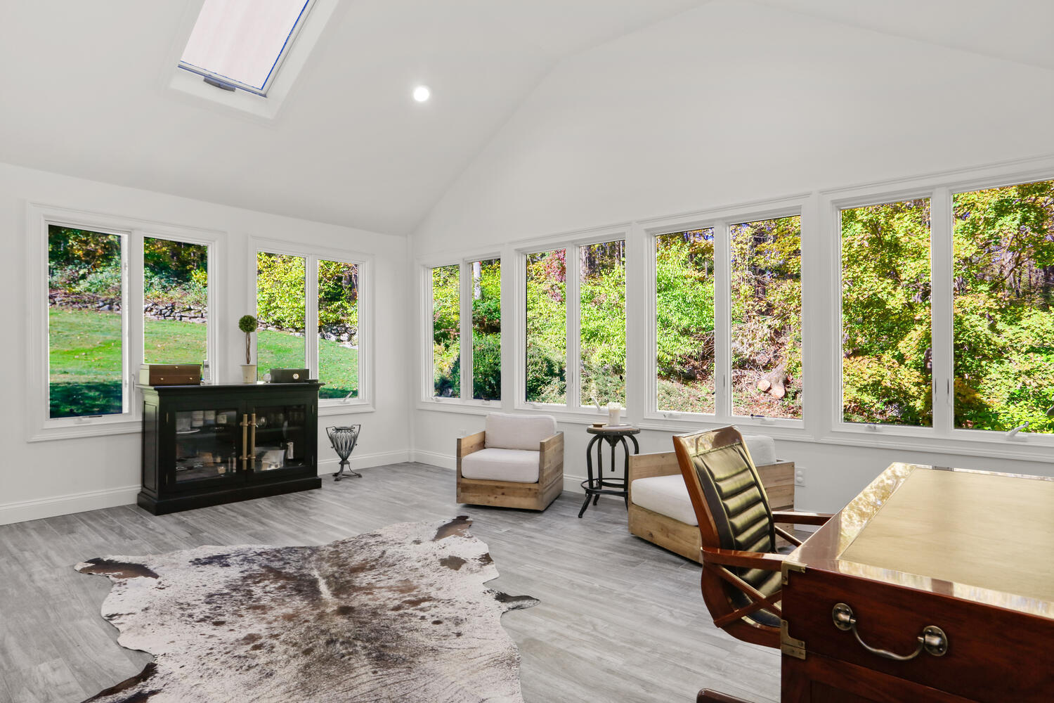 182 Deep Valley Road New Canaan, CT 06840 - Photo 12 of 34 a living room with furniture and a flat screen tv next to a large window