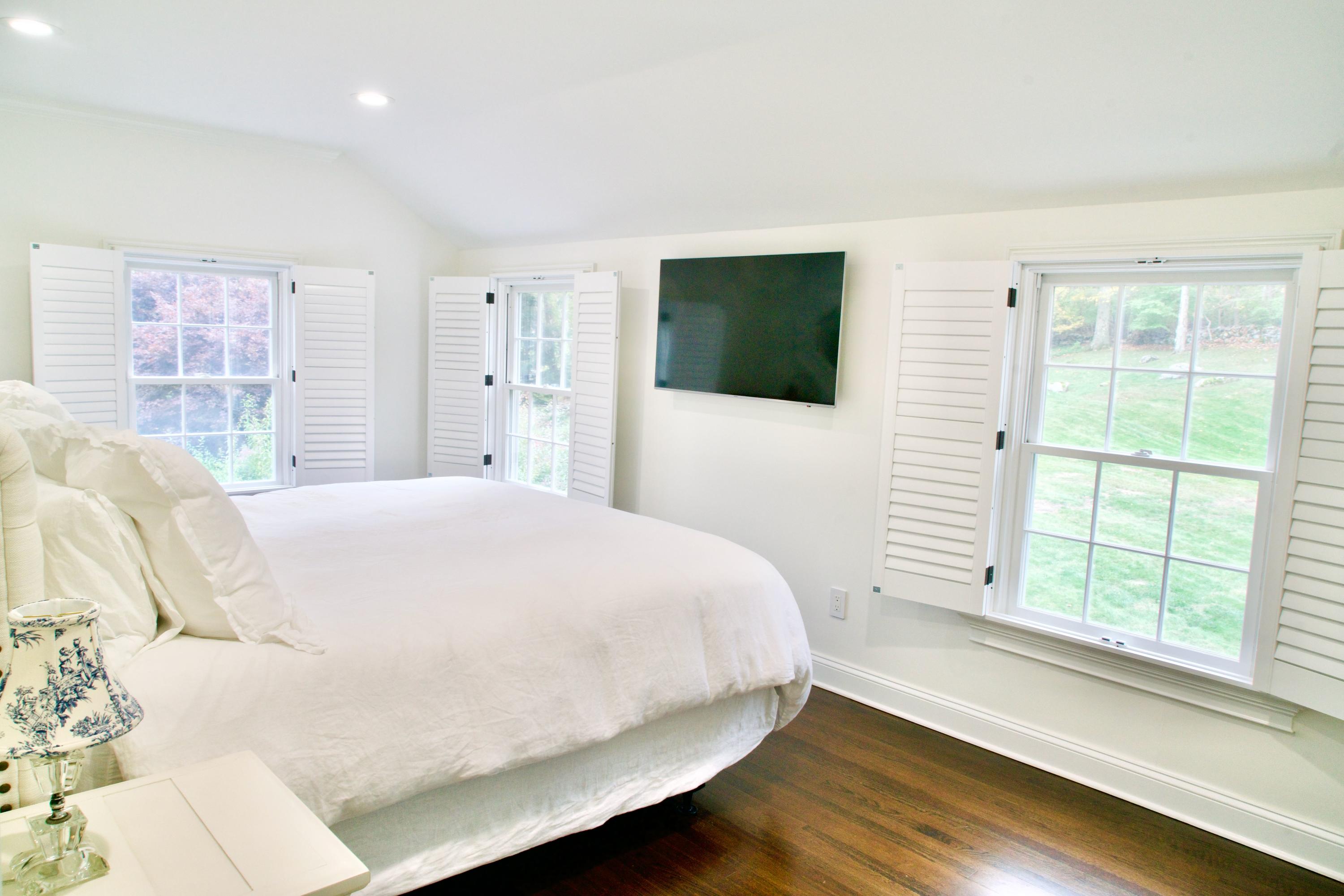 182 Deep Valley Road New Canaan, CT 06840 - Photo 19 of 34 a bed sitting in a bedroom next to a window