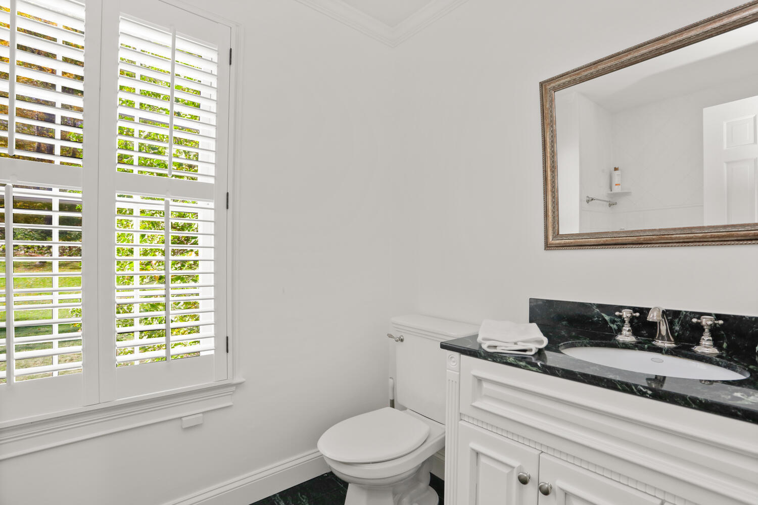 182 Deep Valley Road New Canaan, CT 06840 - Photo 20 of 34 a bathroom with a toilet a sink and a window