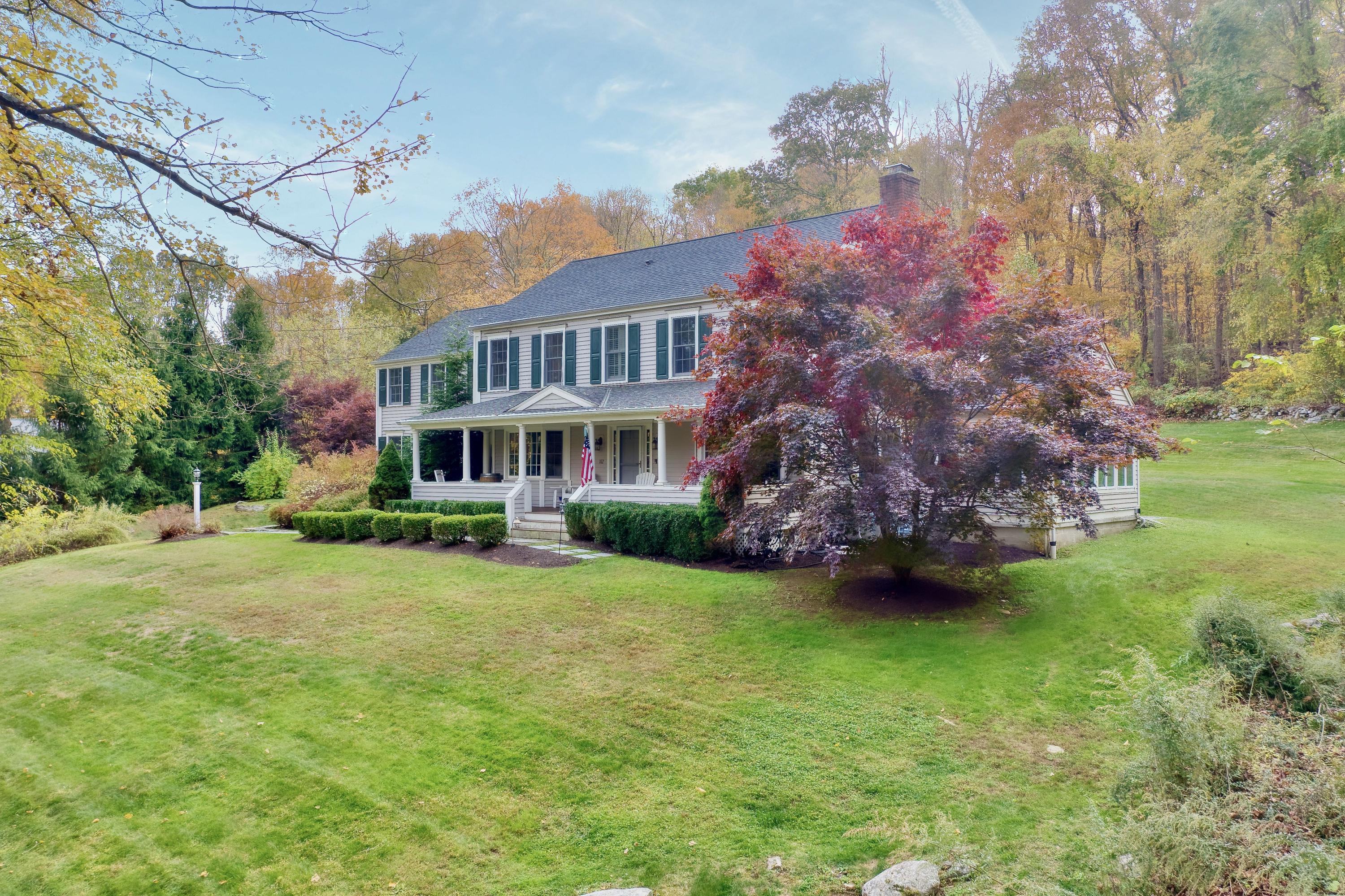 182 Deep Valley Road New Canaan, CT 06840 - Photo 24 of 34 a front view of a house with a garden