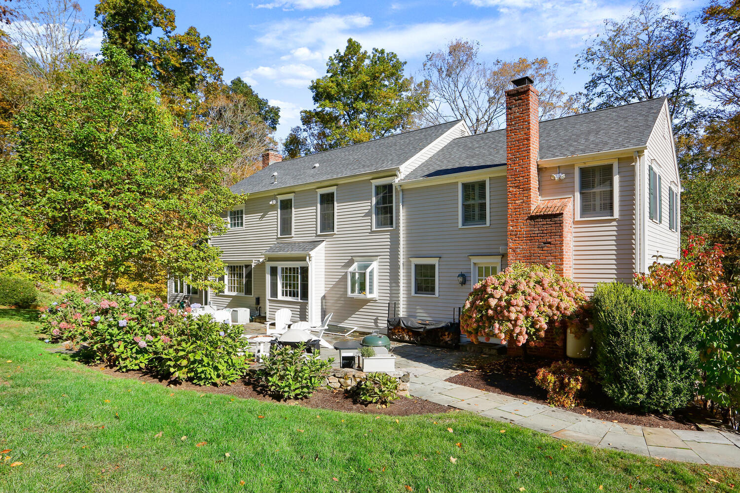 182 Deep Valley Road New Canaan, CT 06840 - Photo 25 of 34 a front view of a house with a garden and plants