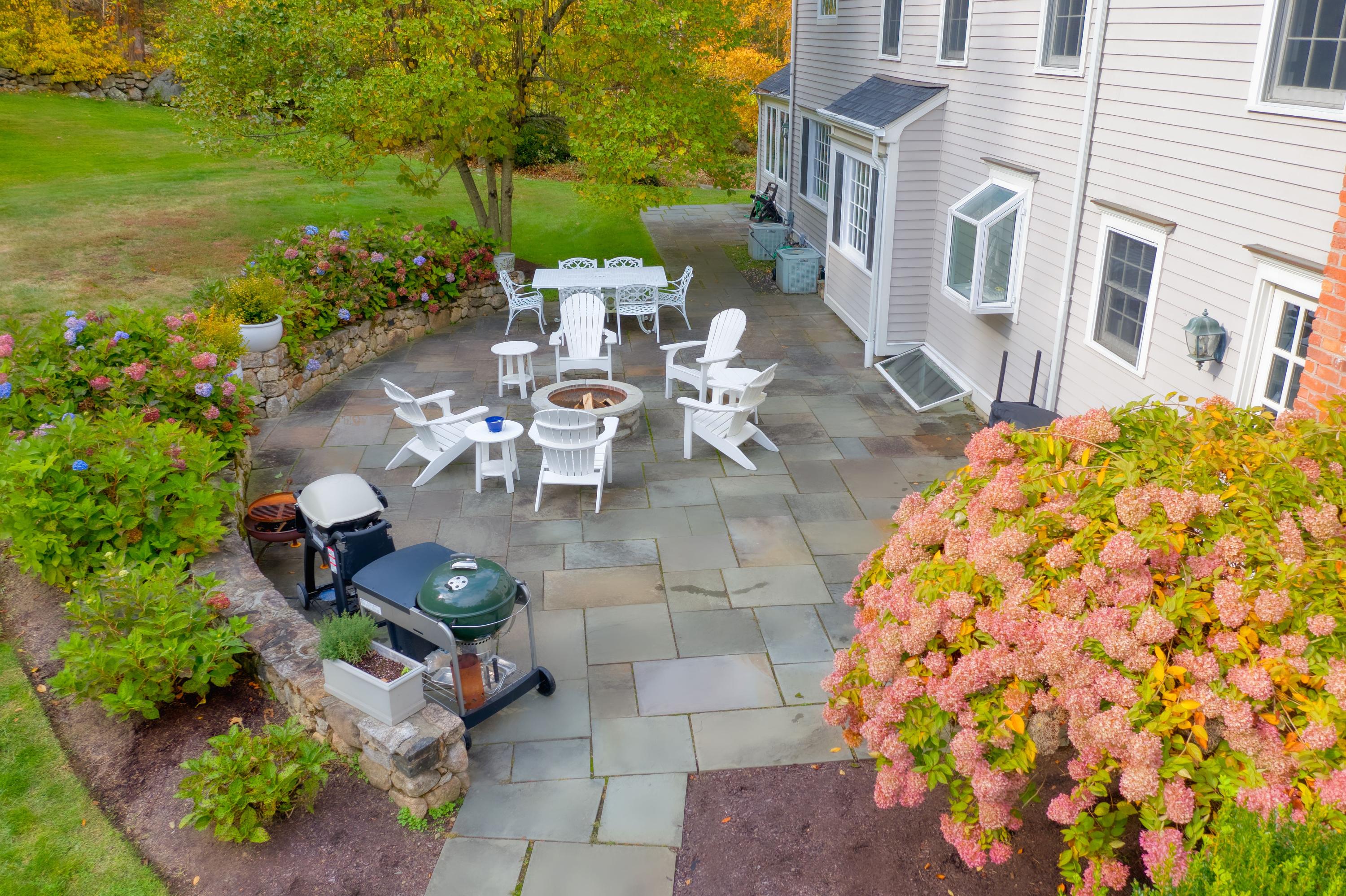 182 Deep Valley Road New Canaan, CT 06840 - Photo 28 of 34 a view of a patio with table and chairs and potted plants