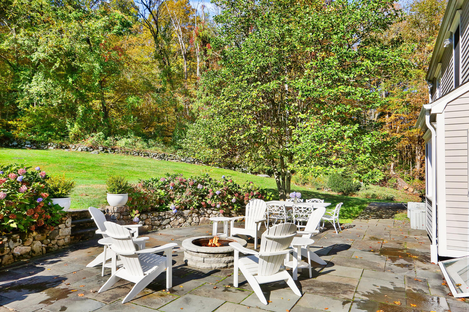 182 Deep Valley Road New Canaan, CT 06840 - Photo 29 of 34 a view of a patio with table and chairs and potted plants