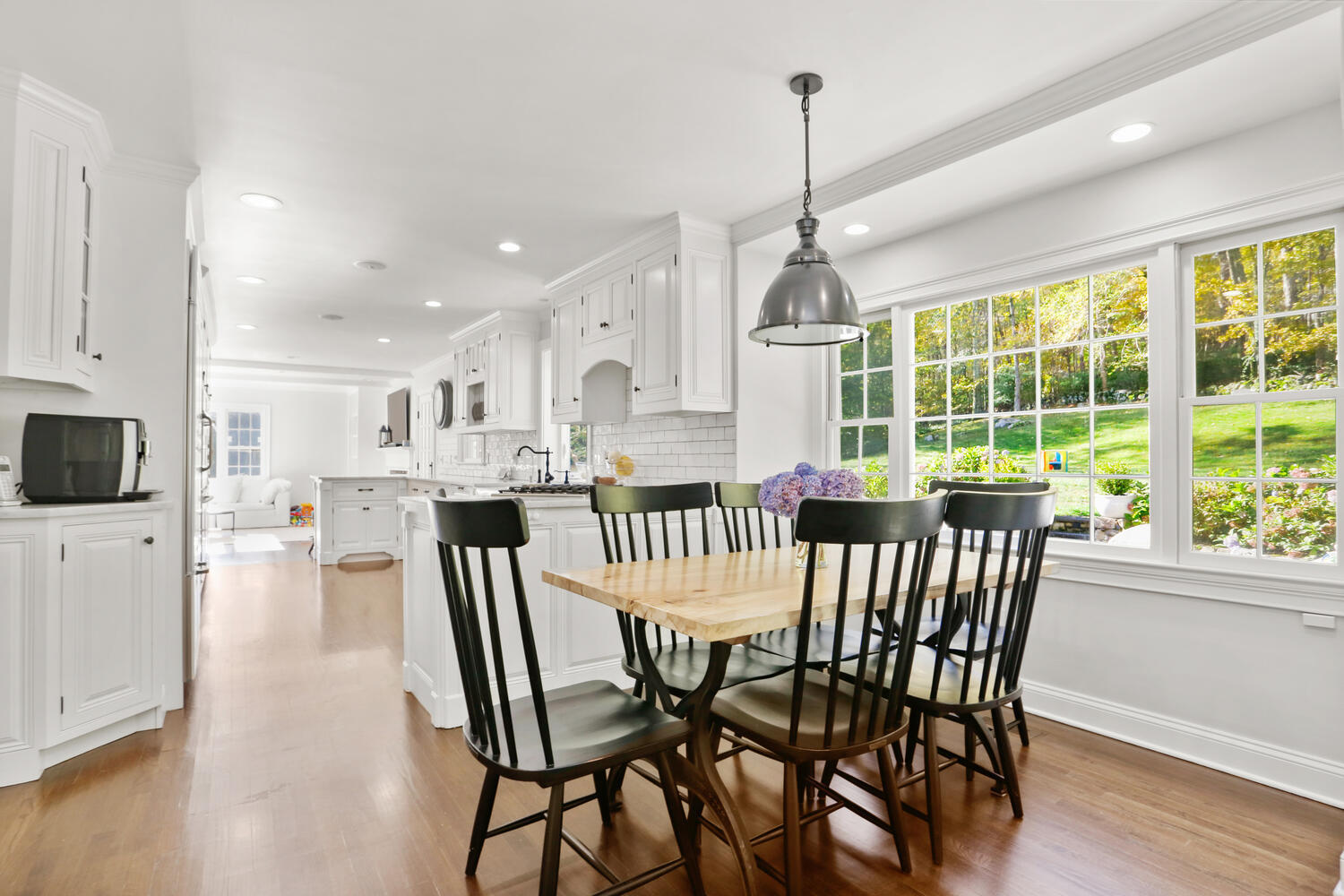 182 Deep Valley Road New Canaan, CT 06840 - Photo 9 of 34 a view of a dining room and livingroom with furniture wooden floor a chandelier