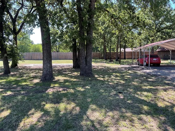 a view of a yard with trees