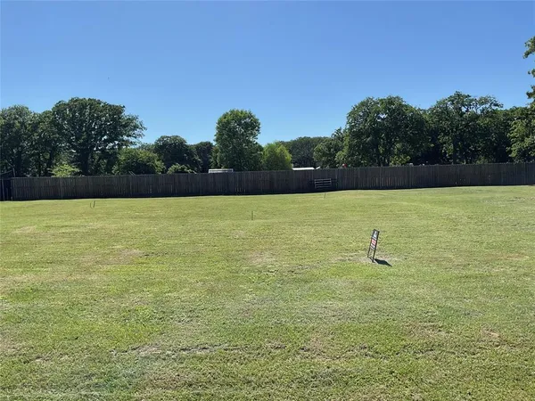 a view of a swimming pool and trees in the background