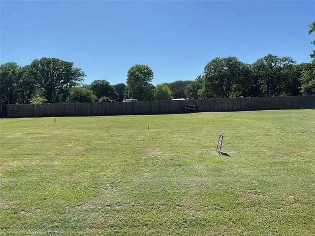 a view of a swimming pool and trees in the background