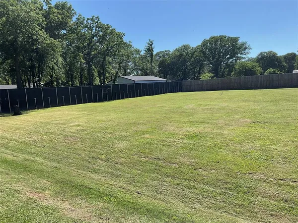 a swimming pool with trees in the background