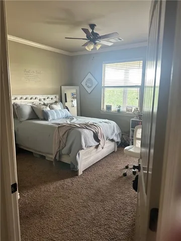 a bedroom with a bed and a large window